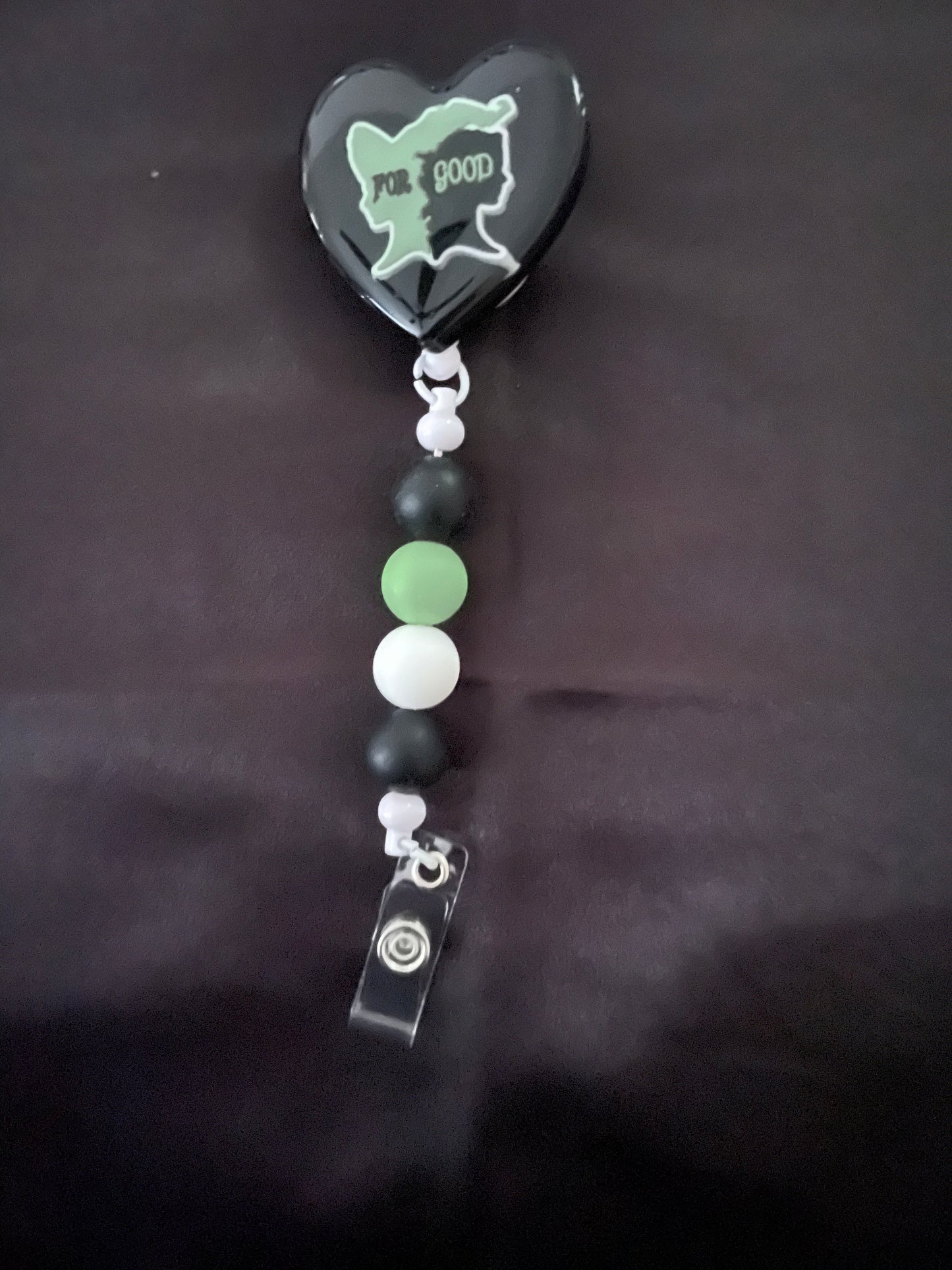 Wicked themed badge reels